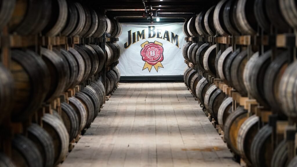 Jim Beam will temporarily halt bourbon production at its Kentucky distillery starting Jan. 1, as tariffs and oversupply squeeze the industry.
